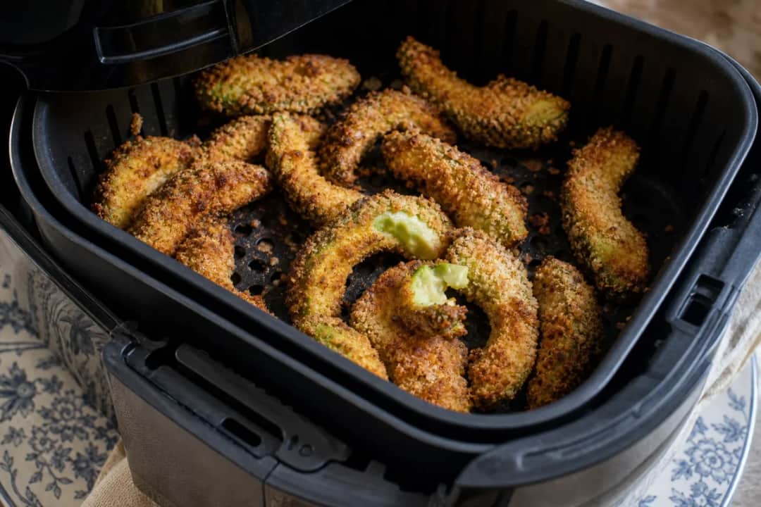 Crispy avocado fries with a golden crust served alongside zesty lime crema.