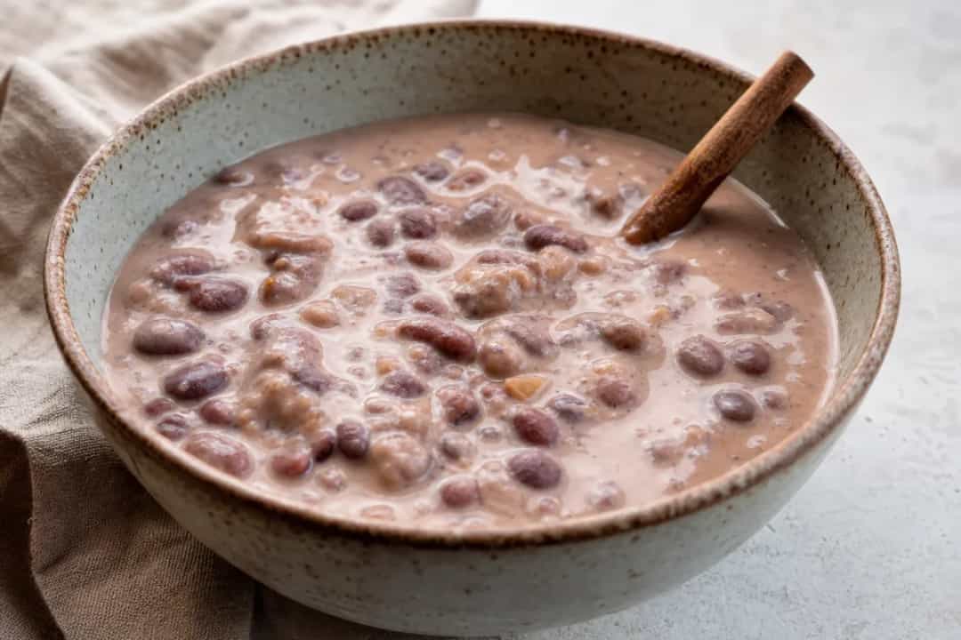 Creamy sweet bean dessert topped with cinnamon and coconut, served in a bowl.